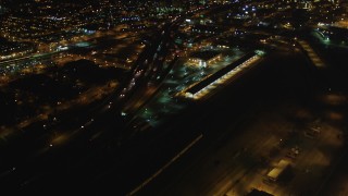 DFKSF07_079 - 5K stock footage aerial video fly over I-880, tilt revealing Downtown Oakland, California, night