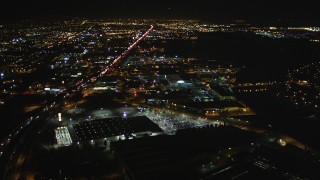 DFKSF07_088 - 5K stock footage aerial video of flying over I-880 freeway and warehouses, Oakland, California, night