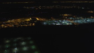 DFKSF07_090 - 5K aerial stock footage of flying by Oakland International Airport, Oakland, California, night