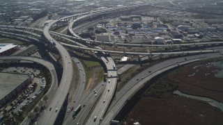 DFKSF08_003 - 5K aerial stock footage of orbiting the MacArthur Maze freeway interchange, Oakland, California