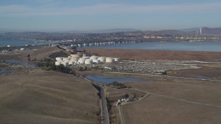 DFKSF08_065 - 5K aerial stock footage of flying by oil refinery, Benicia-Martinez Bridge, Copart Auction, Martinez, California