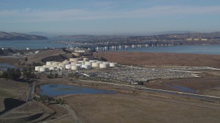 DFKSF08_066 - 5K aerial stock footage of passing by oil refinery, Beinicia-Martinez Bridge, Copart Auction, Martinez, California
