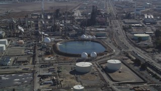 DFKSF08_067 - 5K aerial stock footage of flying by pond at Tesoro Golden Eagle Refinery, Pacheco, California