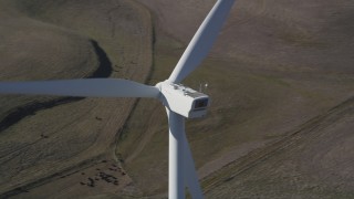 DFKSF08_082 - Aerial stock footage of 5K aerial  video of flying by top of a windmill at Shiloh Wind Power Plant, Montezuma Hills, California