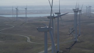 DFKSF08_087 - 5K stock footage aerial video of flying by row of windmills, Shiloh Wind Power Plant, Montezuma Hills, California