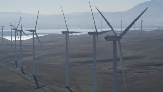 DFKSF08_088 - 5K stock footage aerial video of flying by row of windmills, Shiloh Wind Power Plant, Montezuma Hills, California
