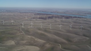 DFKSF08_097 - 5K aerial stock footage of flying by a field of windmills, Shiloh Wind Power Plant, Montezuma Hills, California