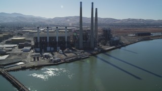 DFKSF08_099 - 5K aerial stock footage tilt from piers to reveal a power plant with smoke stacks in Pittsburg, California