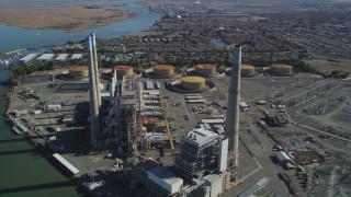 DFKSF08_101 - 5K aerial stock footage of a reverse view of smoke stacks at a bayside power plant in Pittsburg, California