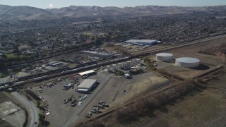 DFKSF08_102 - 5K aerial stock footage track a train traveling near residential neighborhoods; Pittsburg, California