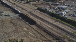 DFKSF08_104 - 5K aerial stock footage of passing in front of a moving train, Pittsburg, California