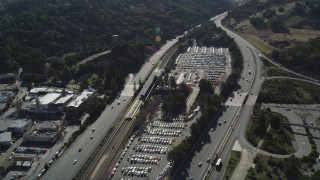 DFKSF09_007 - 5K aerial stock footage fly over Highway 24 freeway, track a BART station and parking lots, Orinda, California