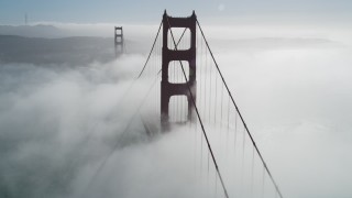 DFKSF09_025 - 5K aerial stock footage flyby the Golden Gate Bridge shrouded in fog, San Francisco, California