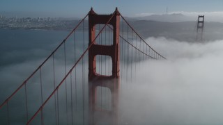 DFKSF09_026 - 5K stock footage aerial video of flying above fog over Golden Gate Bridge, and reveal Downtown San Francisco, California