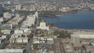 DFKSF09_058 - 5K stock footage aerial video of flying by Lake Merritt and Downtown Oakland, California