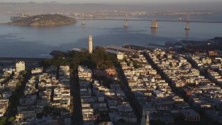 DFKSF10_003 - 5K aerial stock footage of zooming in on Coit Tower in North Beach, San Francisco, California, sunset