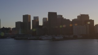DFKSF10_008 - 5K aerial stock footage of waterfront skyscrapers and Ferry Building in Downtown San Francisco, California at sunset