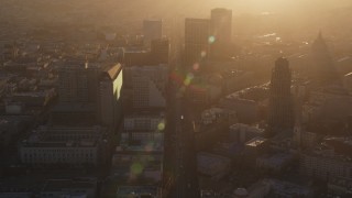 DFKSF10_011 - 5K aerial stock footage of flying over Market Street through Civic Center, Downtown San Francisco, California at sunset