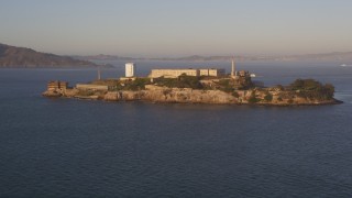 DFKSF10_017 - 5K aerial stock footage of approaching Alcatraz prison San Francisco, California, sunset