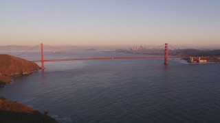 DFKSF10_035 - 5K aerial stock footage of flying over Marin Hills, reveal Golden Gate Bridge in San Francisco, California, sunset