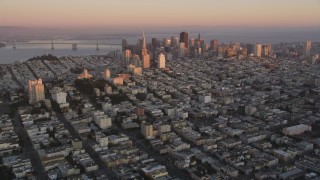 DFKSF10_045 - 5K aerial stock footage approach Russian Hill apartment buildings and Downtown San Francisco skyscrapers, California, sunset