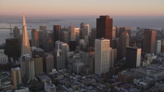 DFKSF10_047 - 5K aerial stock footage of approaching city skyscrapers, Downtown San Francisco, California, sunset