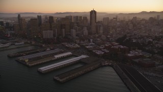 DFKSF10_063 - 5K aerial stock footage pan from Coit Tower, revealing Downtown San Francisco skyscrapers, California, sunset