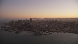 DFKSF10_065 - 5K aerial stock footage of flying away from Downtown San Francisco piers and skyscrapers, California, twilight