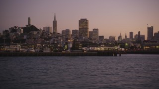 DFKSF10_072 - 5K aerial stock footage of flying by Fisherman's Wharf, revealing Pier 39, San Francisco, California, twilight