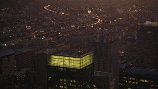 DFKSF10_076 - 5K aerial stock footage fly over skyscrapers, reveal freeway and police station in South of Market, San Francisco, California, twilight