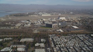DFKSF11_019 - 5K aerial stock footage of flying by Moffett Field and NASA Ames Research Center, Mountain View, California