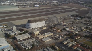 DFKSF11_020 - 5K aerial stock footage tilt from NASA Ames Research Center, reveal Hangar One at Moffett Field, Mountain View, California