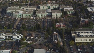 DFKSF12_017 - 5K aerial stock footage tilt from Valley Green Drive revealing Apple Headquarters office buildings, Cupertino, California