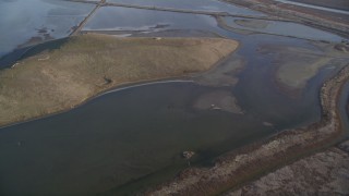 DFKSF12_035 - 5K aerial stock footage of a reverse view of marshland in Union City, California