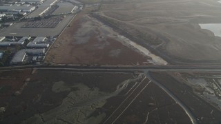 DFKSF12_039 - 5K aerial stock footage of a reverse view of marshland, Hayward, California
