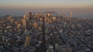 DFKSF14_003 - 5K aerial stock footage of flying by Market Street and skyscrapers in Downtown San Francisco, California, sunset