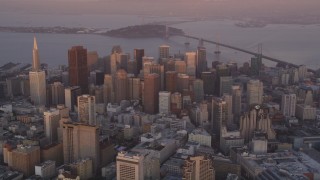 DFKSF14_015 - 5K stock footage aerial video of flying toward city buildings and skyscrapers in Downtown San Francisco, California, sunset