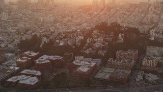 DFKSF14_019 - 5K aerial stock footage of flying by iconic Coit Tower in North Beach, San Francisco, California, sunset