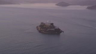 DFKSF14_020 - 5K aerial stock footage of approaching Alcatraz island prison, San Francisco, California, twilight