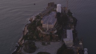 DFKSF14_022 - 5K aerial stock footage flyby main buildings and lighthouse on Alcatraz island, San Francisco, California, twilight