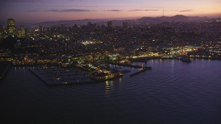 DFKSF14_061 - 5K aerial stock footage of flying by Pier 39 and Fisherman's Wharf, San Francisco, California, twilight
