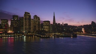 DFKSF14_066 - 5K aerial stock footage of passing waterfront skyscrapers in Downtown San Francisco, California, twilight