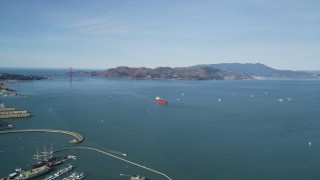 DFKSF15_018 - 5K aerial stock footage of approaching an oil tanker sailing San Francisco Bay, California with a view of the Golden Gate Bridge