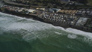 DFKSF15_051 - 5K aerial stock footage of flying by oceanfront homes as waves roll in, Pacifica, California