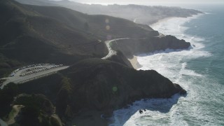 DFKSF15_060 - 5K aerial stock footage video of following Highway 1 along the coast, winding above cliffs, Montara, California