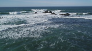 DFKSF15_073 - 5K aerial stock footage tilt to reveal rock formations and fly out over ocean, Half Moon Bay, California
