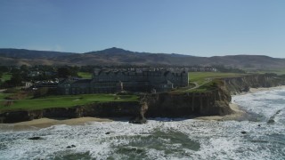 DFKSF15_074 - 5K aerial stock footage of flying by an oceanfront hotel on coastal cliffs, Half Moon Bay, California