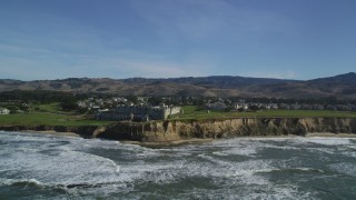 DFKSF15_077 - 5K aerial stock footage of a reverse view of The Ritz Carlton hotel on coastal cliffs, Half Moon Bay, California