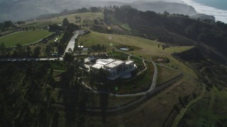 DFKSF15_086 - 5K aerial stock footage approach an isolated mansion on a hilltop near the coast, San Gregorio, California