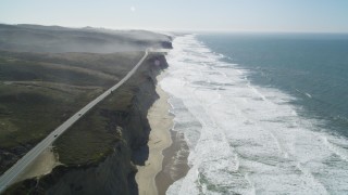 DFKSF15_090 - 5K aerial stock footage of tilting from the coastal beach revealing Highway 1, San Gregorio, California